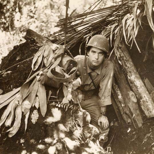 Robert Doyle emerges from a captured Japanese pillbox at Buna, Papua New Guinea.